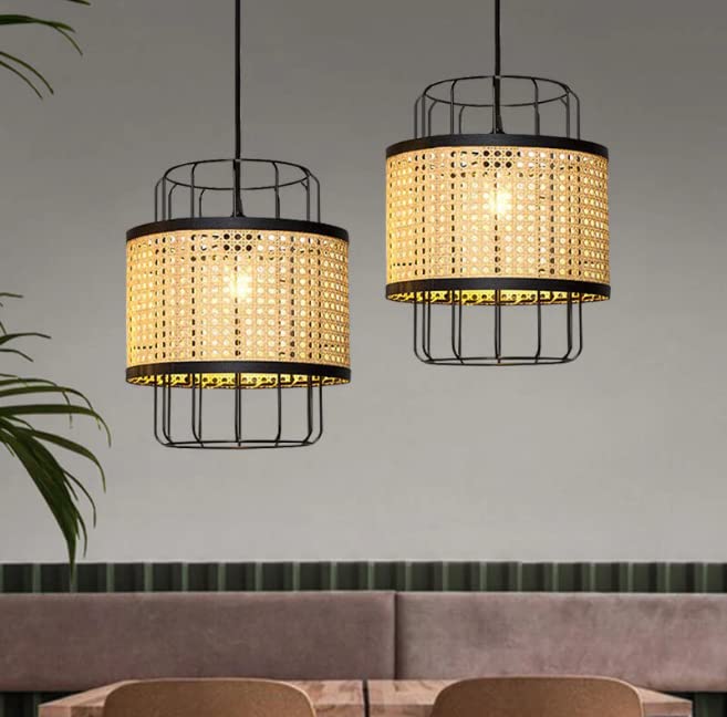 Arissa Cage Pendant light fixture with natural cane webbing and a matte black metal cage, hanging and lit, next to a wooden block with descriptive text against a white wall.