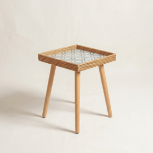 A square accent side table featuring a geometric Mother of Pearl inlay top, a hand-woven natural rattan tray border, and four tapered light wood legs against a neutral backdrop.